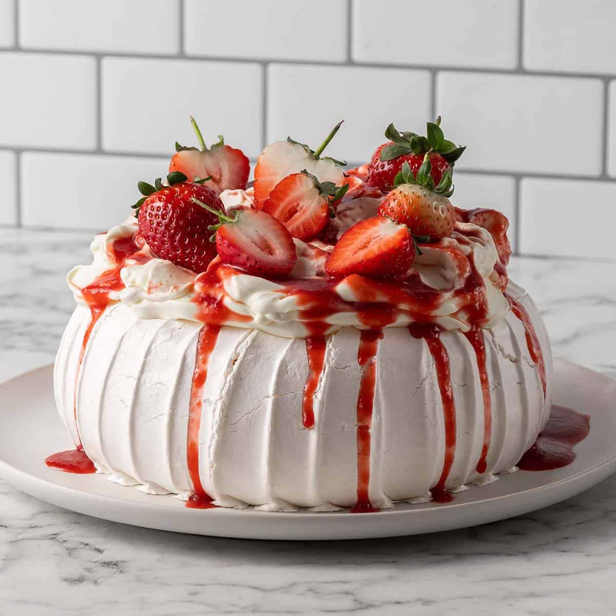 Square image front on shot for a baked meringue topped with fresh strawberries and sauce