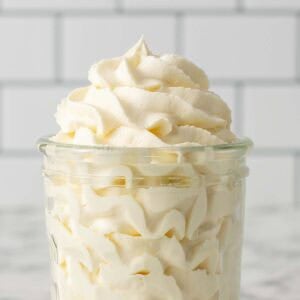 Square close up image of whipped cream in a glass jar