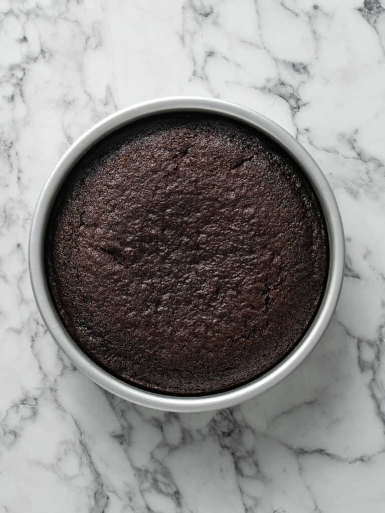 A top down image of a chocolate cake that is baked in a cake tin