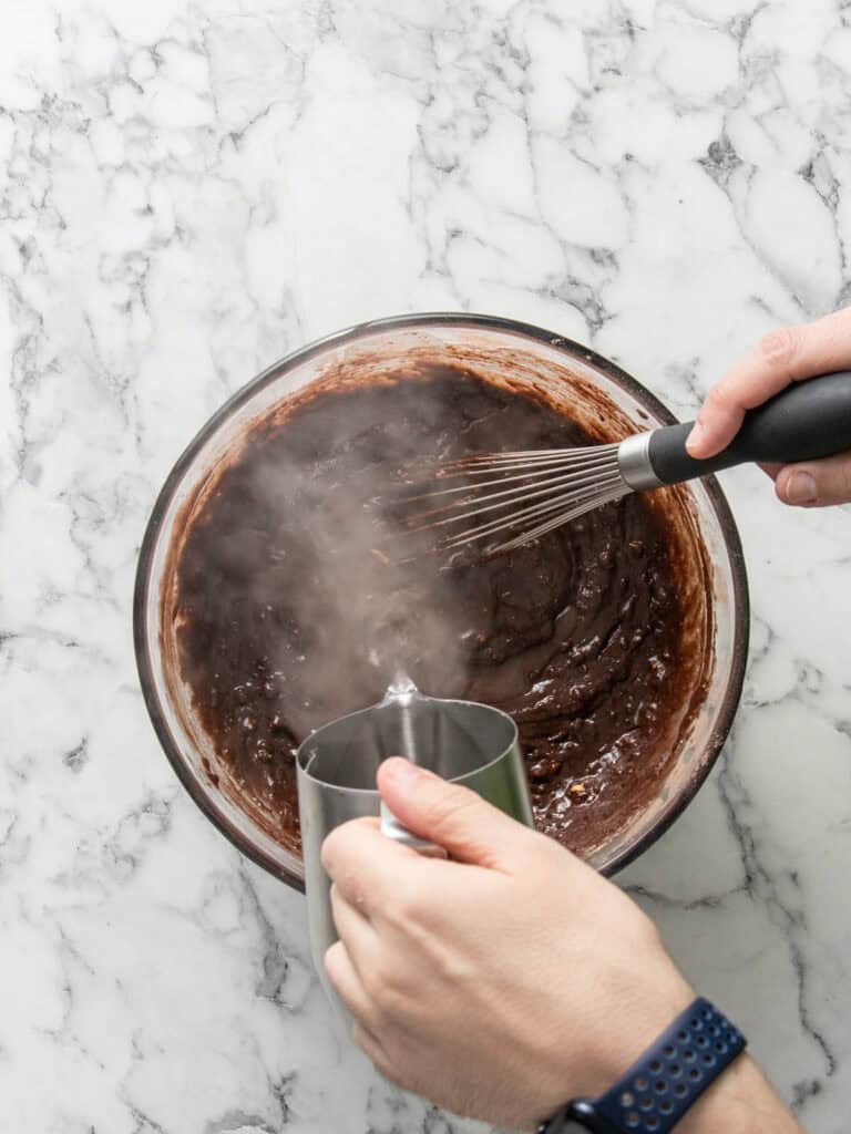 Adding the boiling water to the batter for the chocolate cake