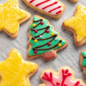 Square image of a green biscuit with Christmas light icing