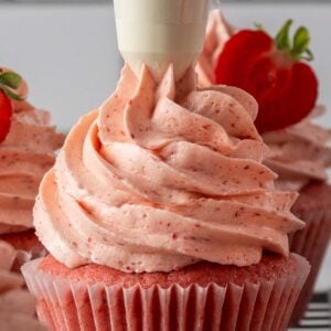 Square thumbnail image - extreme close up of berry flavoured frosting being piped onto a strawberry cupcake