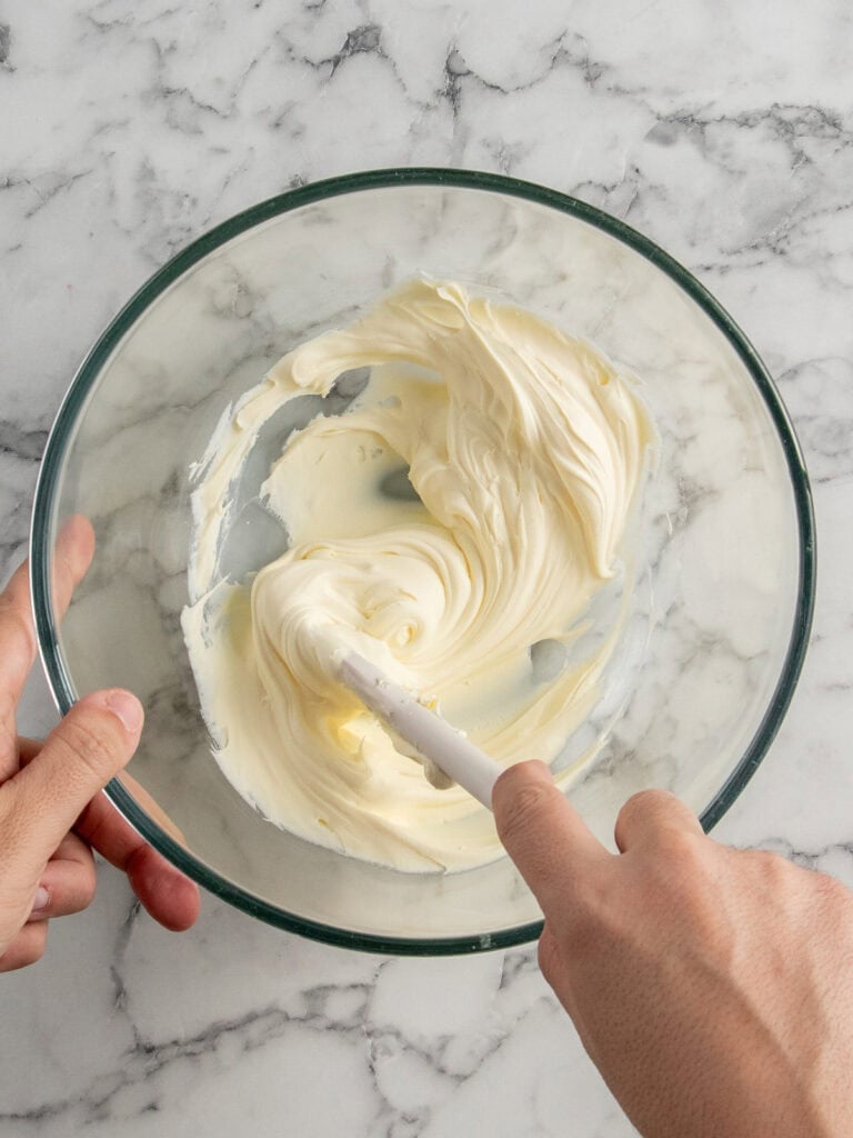 Mixing the mascarpone cheese as the first step in a bowl.