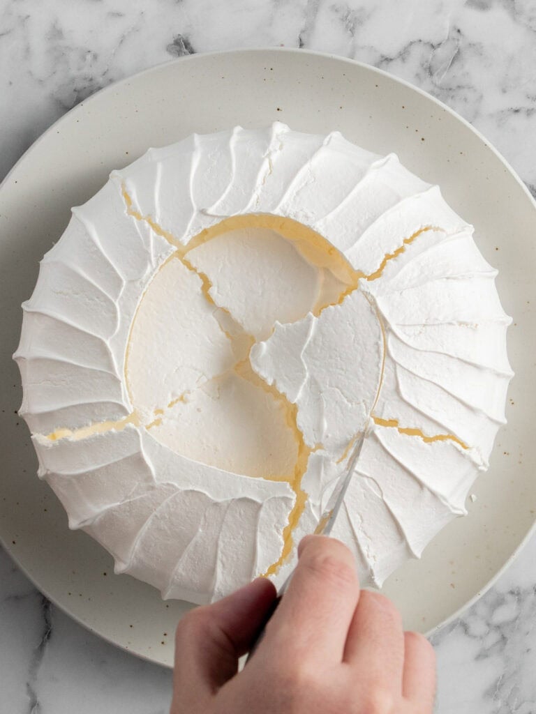 Using a knife to score the crust on the top to stop it collapsing when adding the toppings