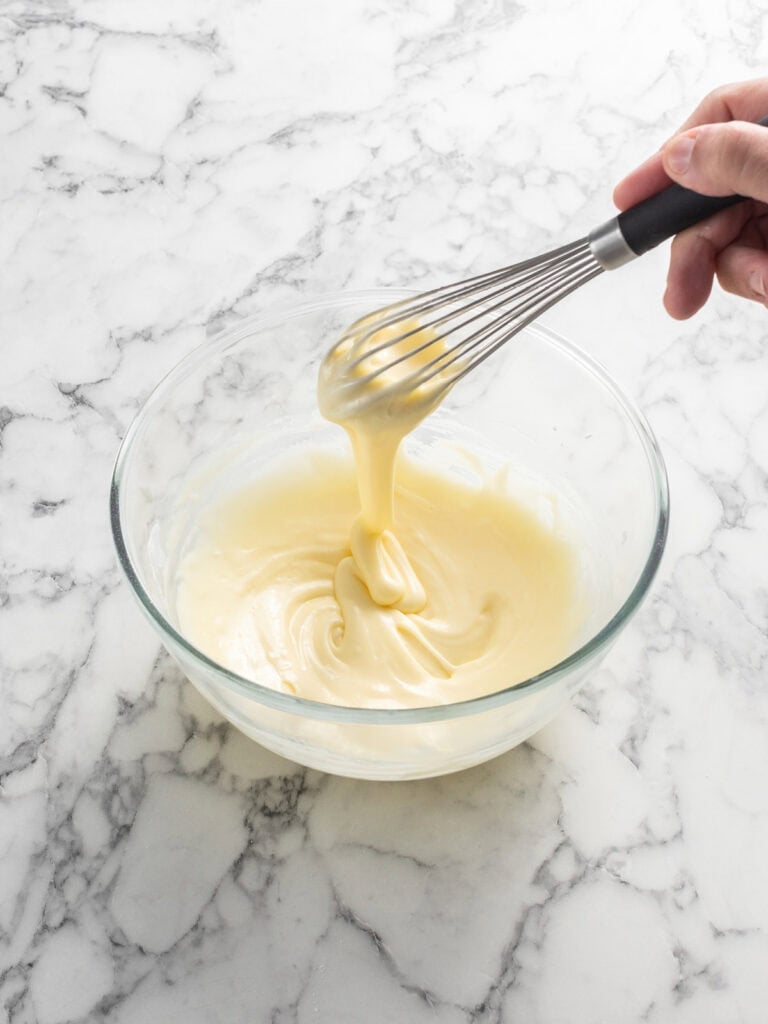 Whisking the glaze ingredients together using a hand whisk