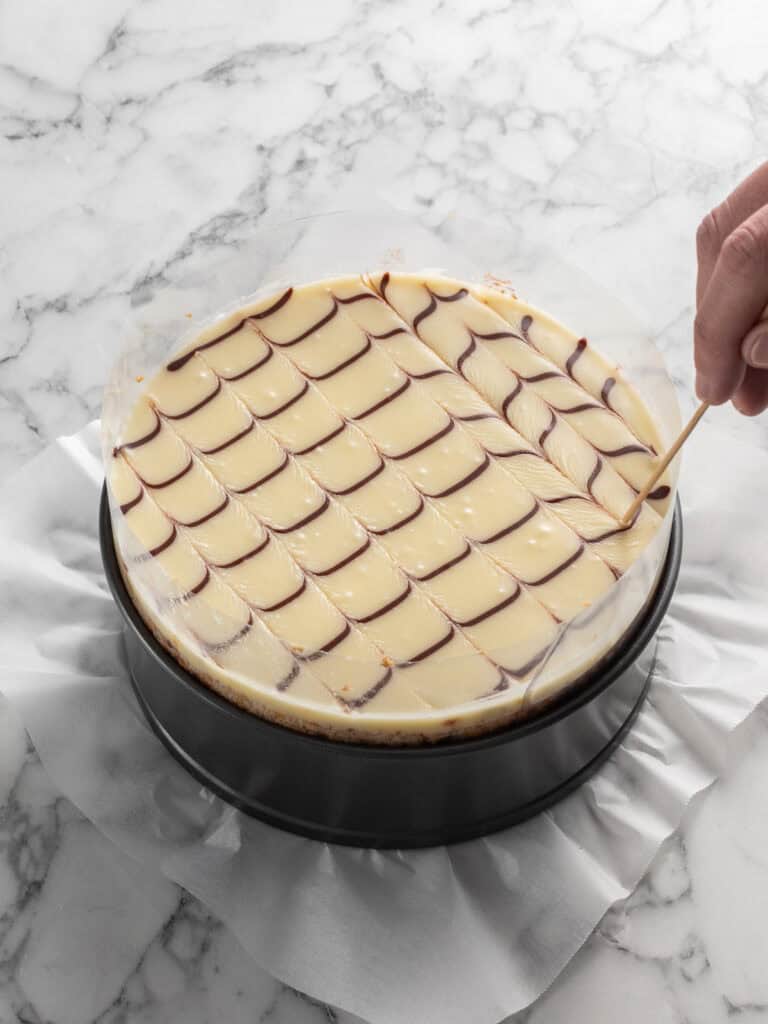 Using a toothpick to feather the glaze