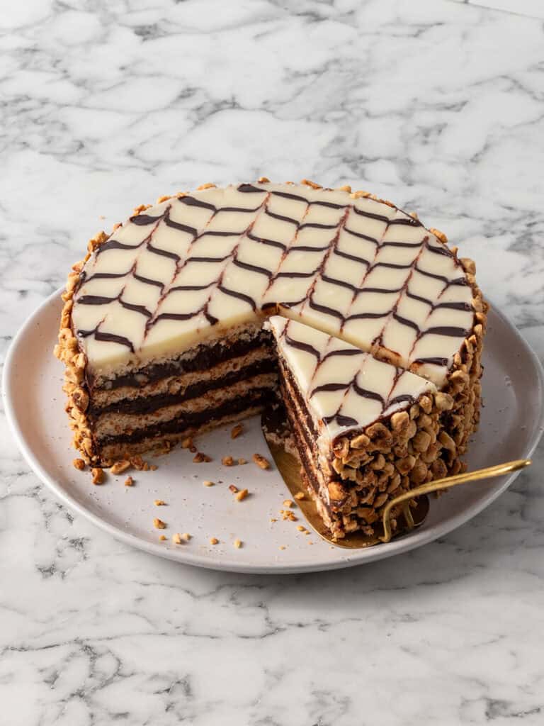 A shot of a chocolate and hazelnut cake that has a slice taken out