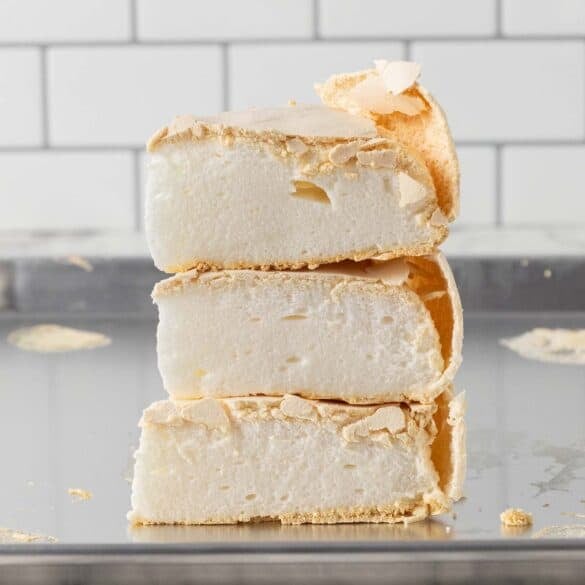A square image of a stack of baked meringue slices on top of each other
