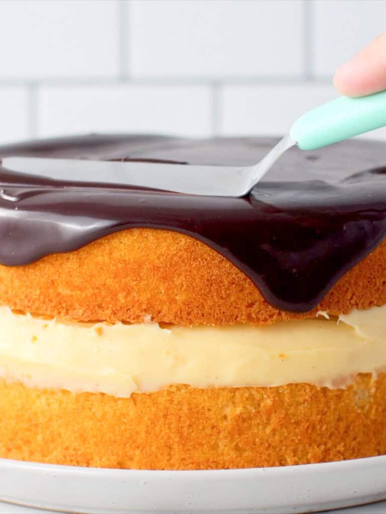 Adding the chocolate sauce to the cake sponge to finish off the cake