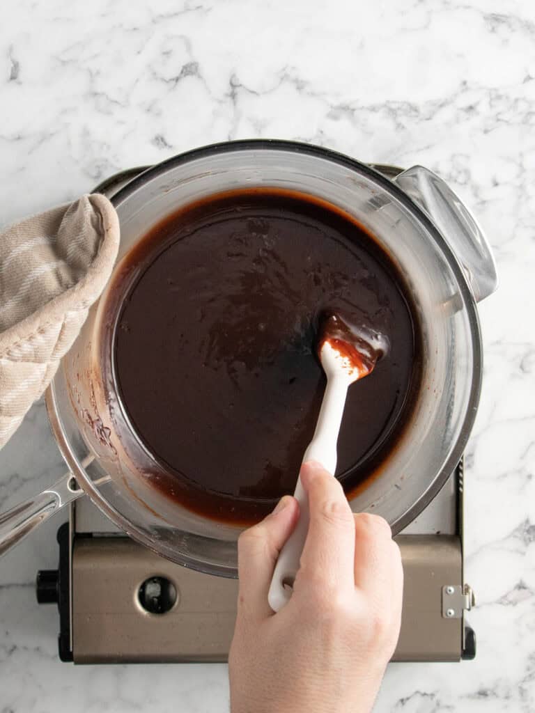 Stirring the fudge sauce to melt together