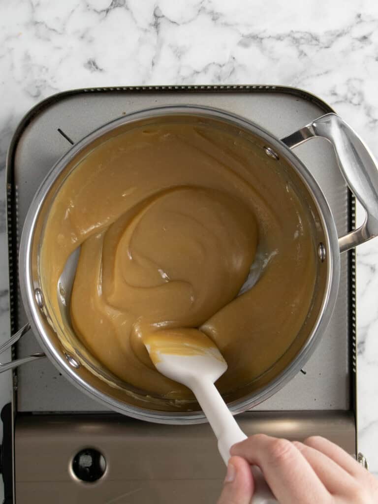 Add all of the caramel layer ingredients into a pot and mix until melted and it begins to bubble