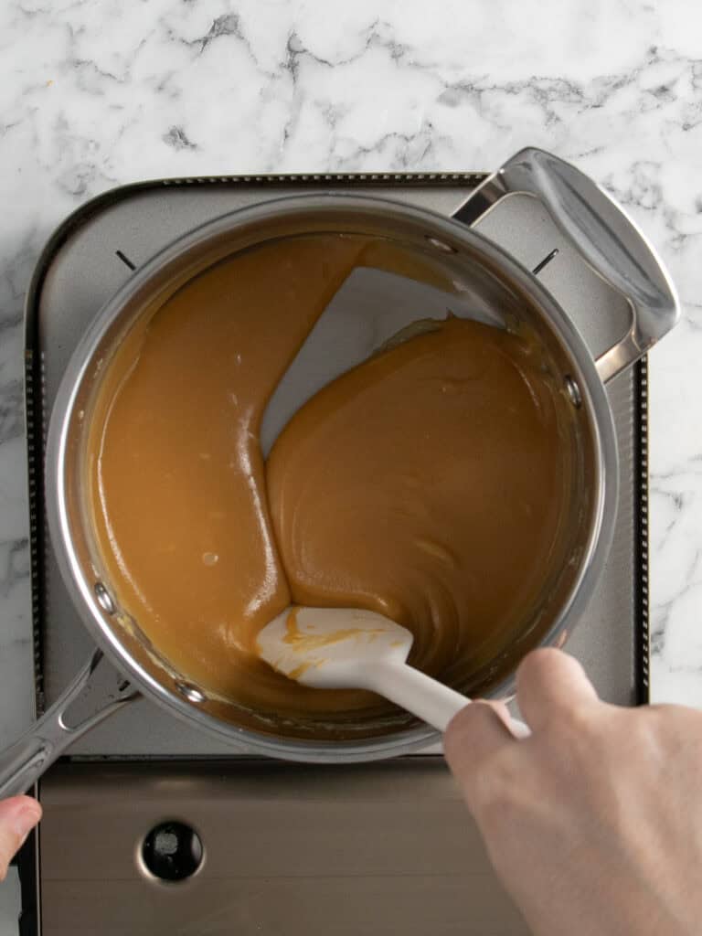 Stir the mixture until it thickens and darkens in colour