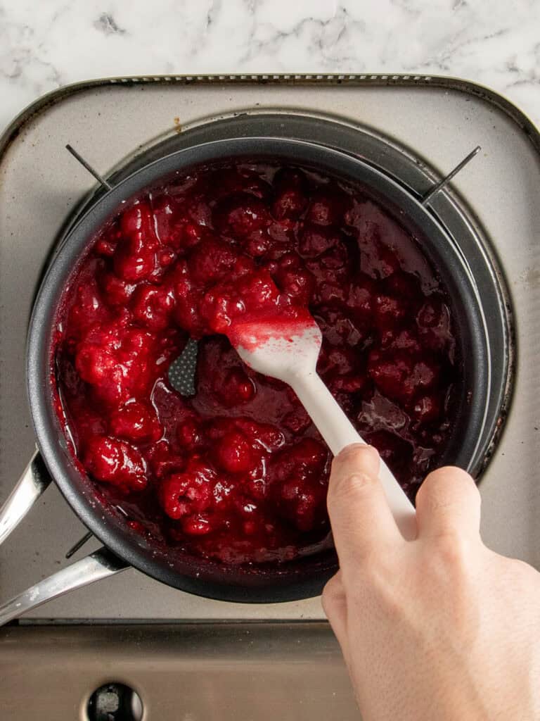 Raspberries beginning to cook down and release their juices