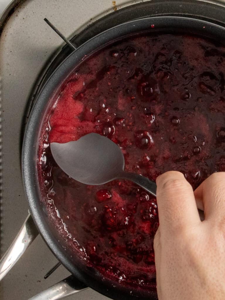 Skimming the froth away using a spoon