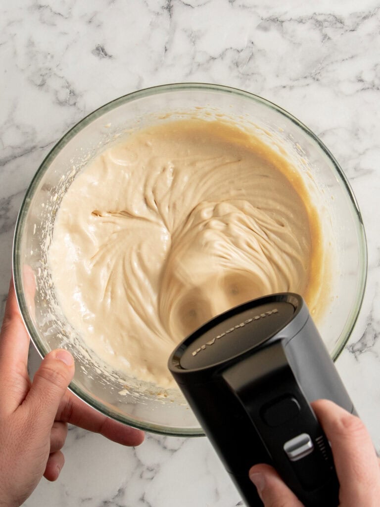 Whisking the eggs, sugars and vanilla until pale and fluffy
