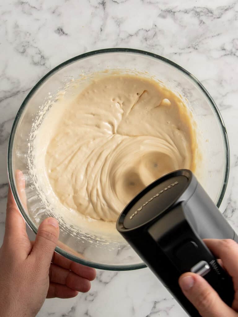 Whisking the eggs and sugar together to melt the sugar