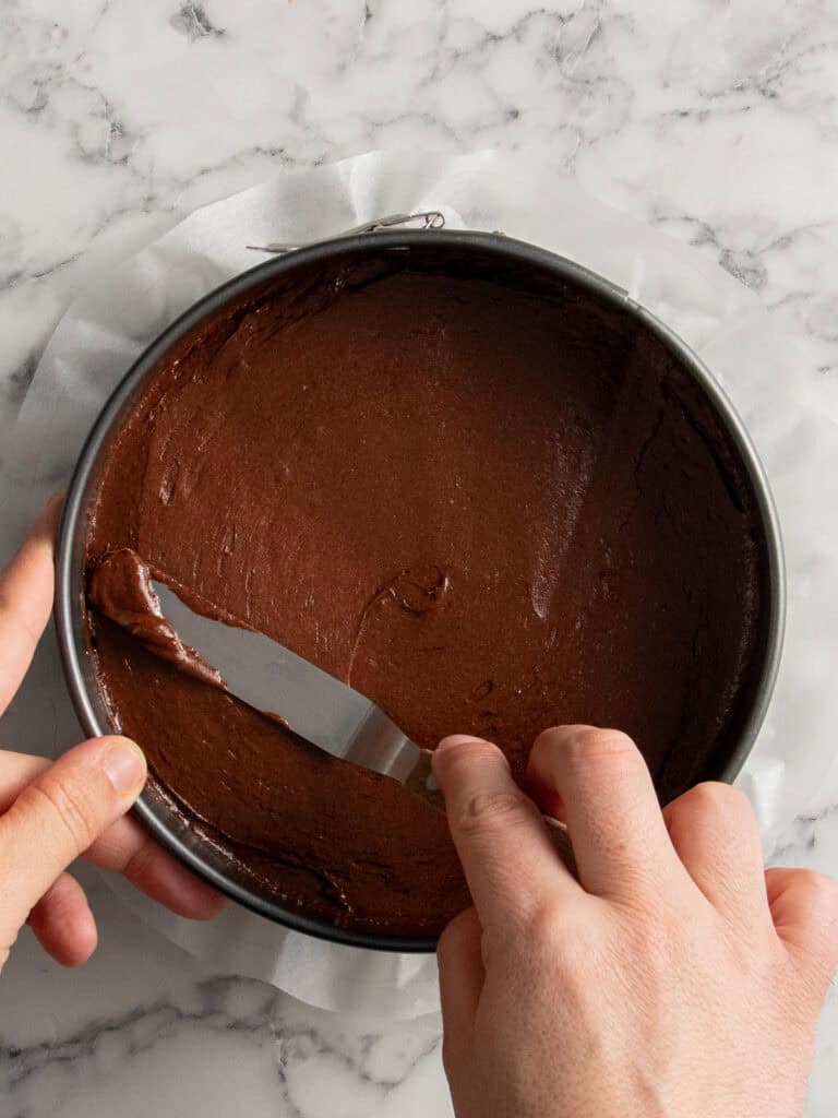 Spreading the brownie dough into the springform pan