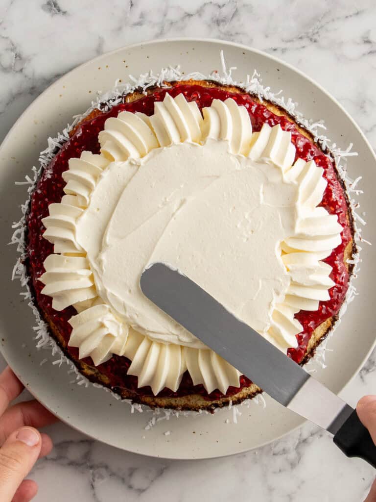 Spreading the cream on top of the cake