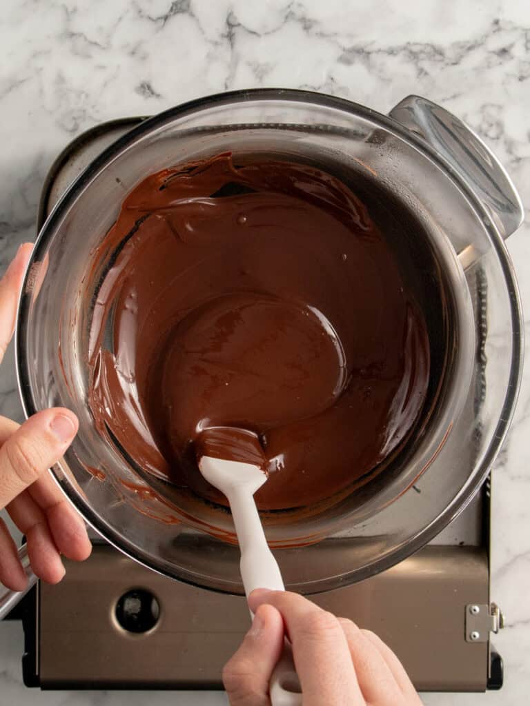 Melting the chocolate and oil together to make the chocolate coating