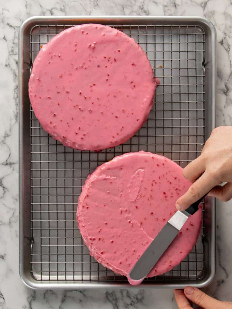 Spreading the pink glaze on top of the sponge