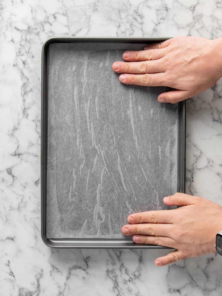 Adding the baking paper to the baking tray