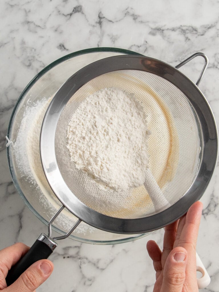 Sifting the dry ingredients into the egg mixture