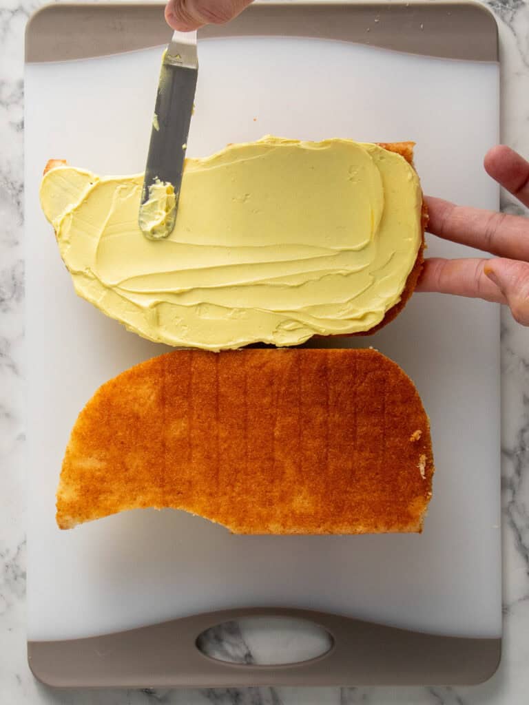 Adding yellow frosting in the middle of the body of the duck