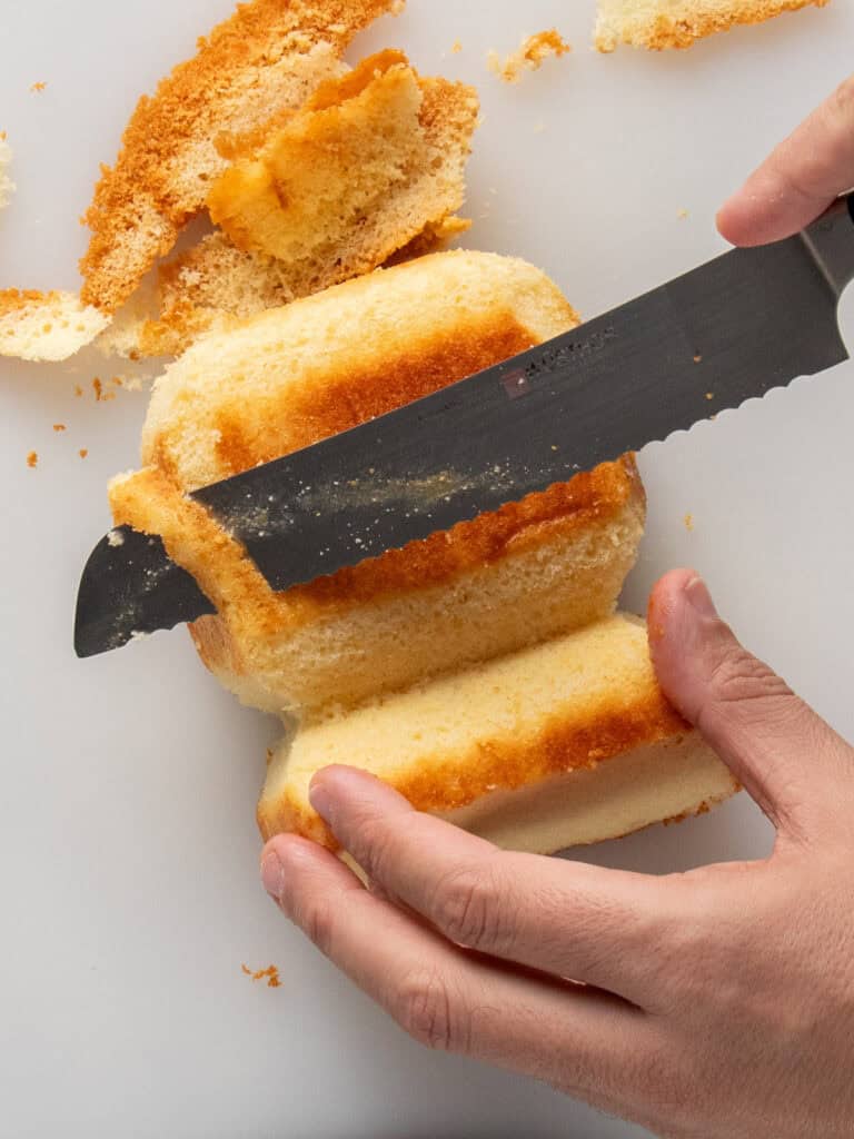 Trimming away pieces of cake on the head to round it out