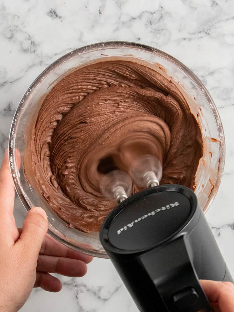 Whipping all the ingredients together to make an easy nostalgic chocolate frosting