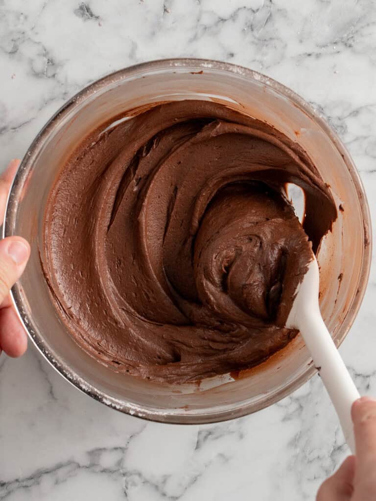 Swirly easy nostalgic chocolate frosting in a mixing bowl