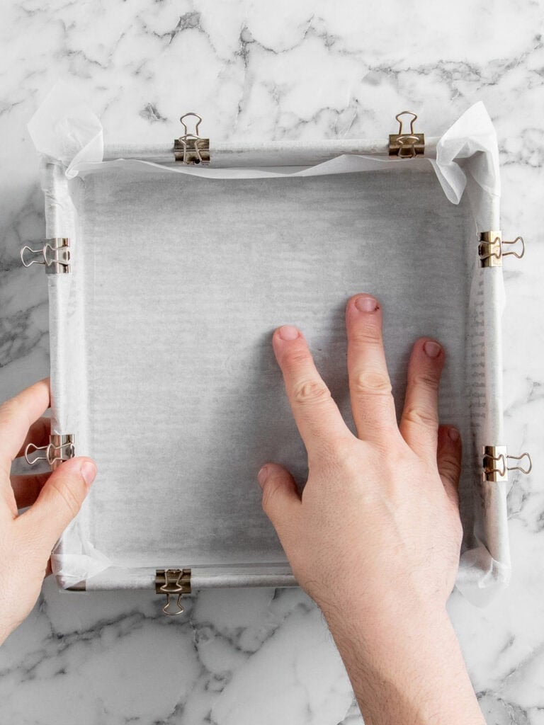 Lining a 9-inch baking tray with baking paper