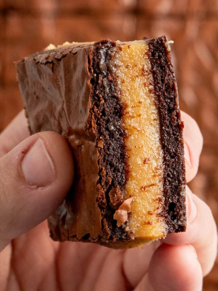 Showing an extreme close up of the layers inside the caramel brownie