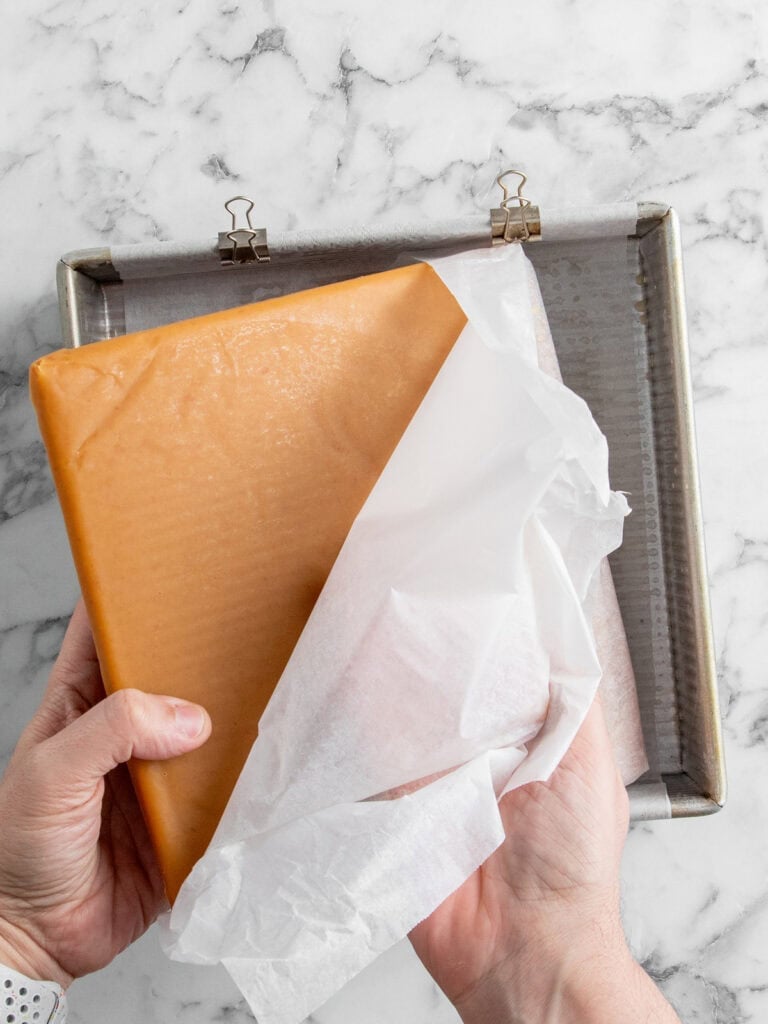 Peeling the baking paper away from the set caramel