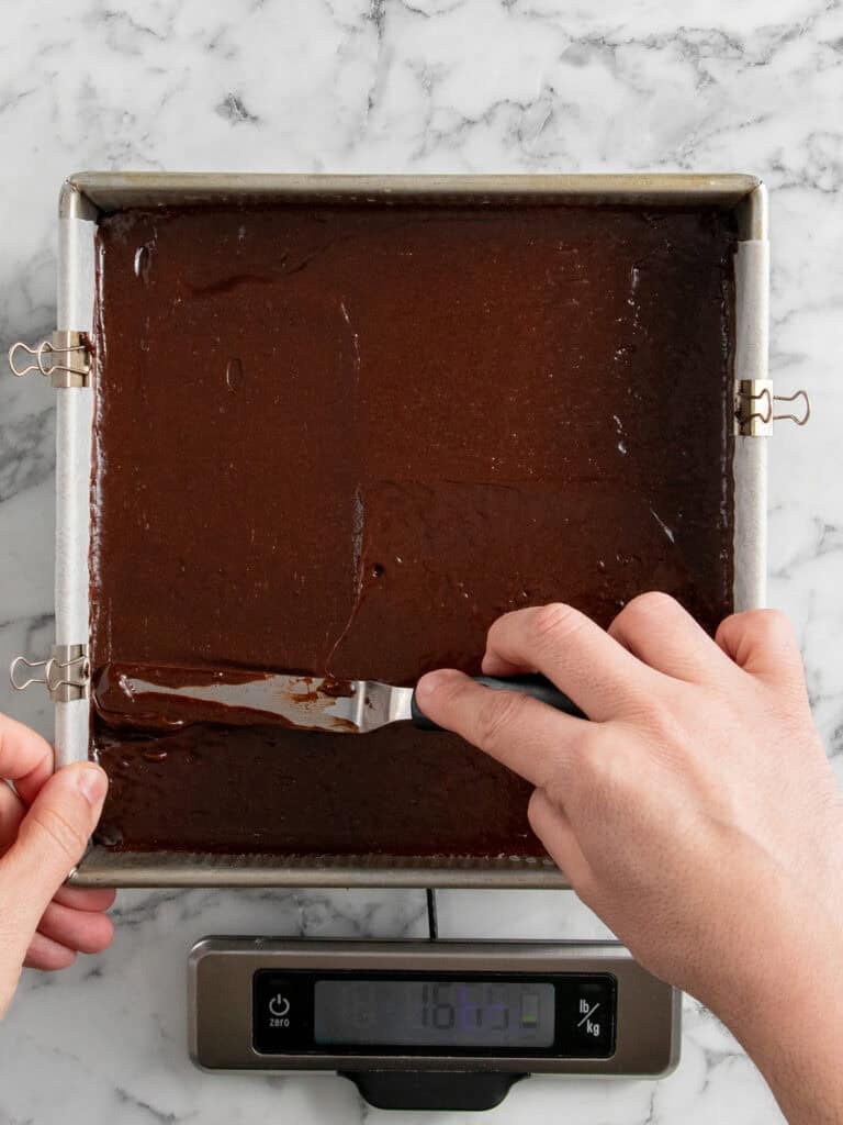 Spreading the remaining chocolate batter on top of the caramel layer