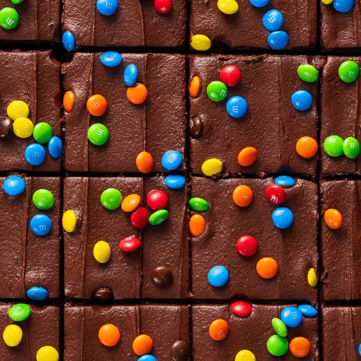 Square image of frosted brownies with m&m's on top