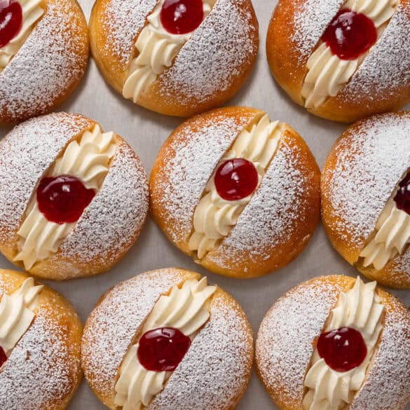 Square image of a top down shot of brioche buns with Chantilly and raspberry jam