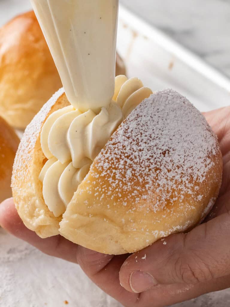 Piping more cream on top to finish it off