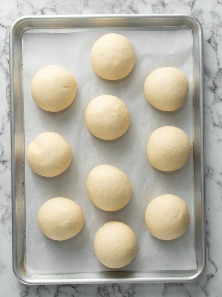 Showing the buns that have tripled in size after resting to rise