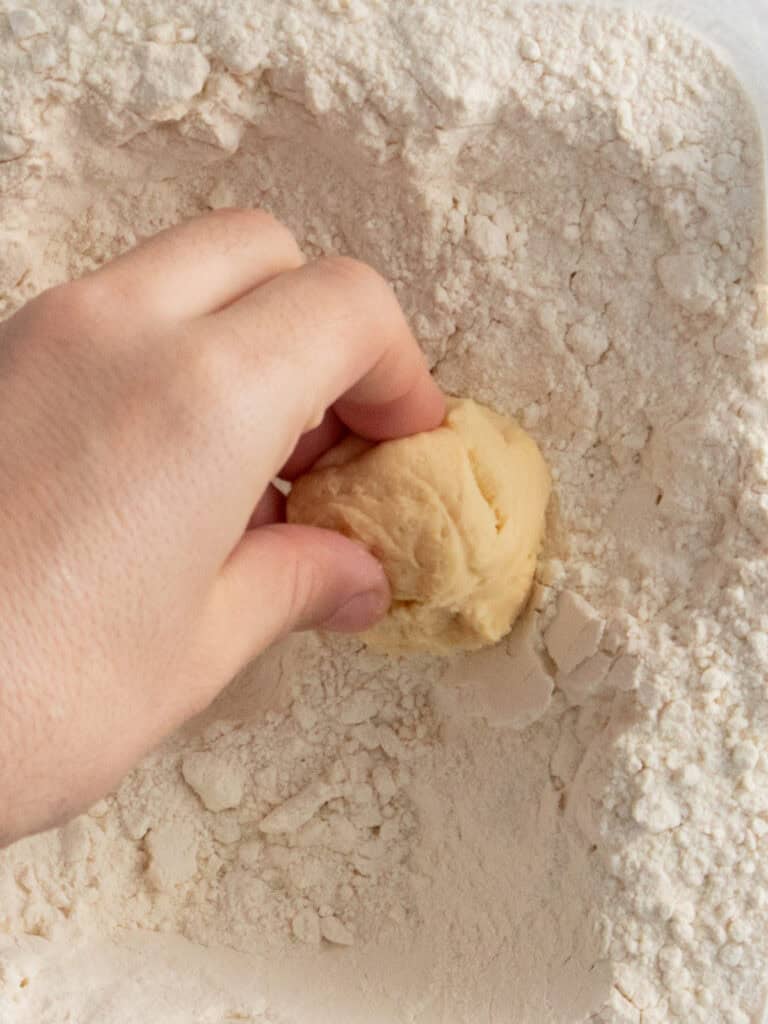 Adding the top of the dough portions into some flour
