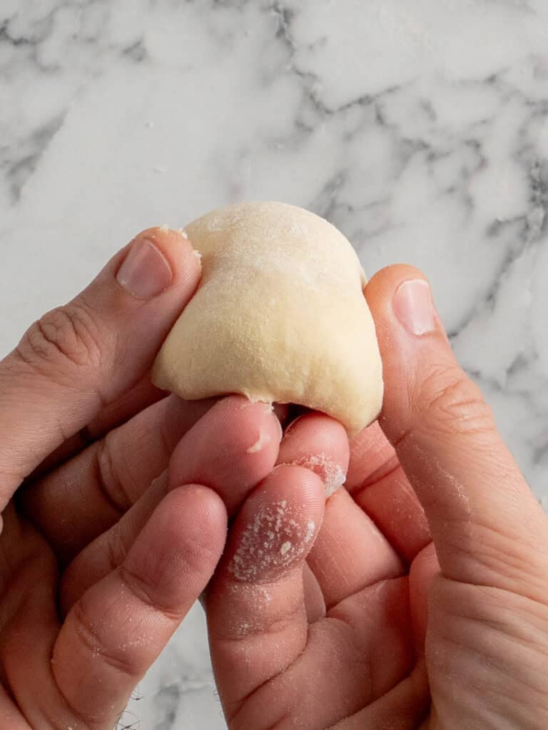 Folding the top of the dough in on itself