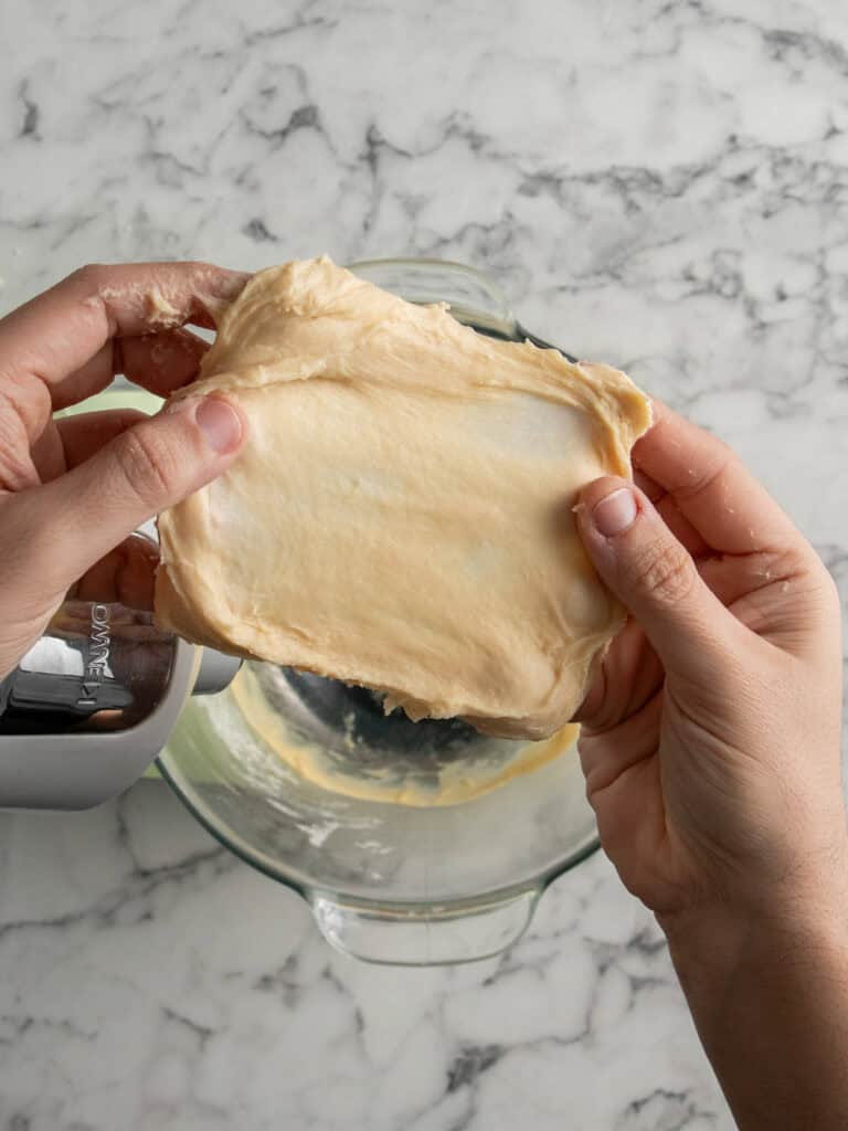 Stretching the dough to show that it doesn't break