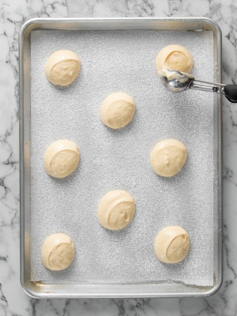 Scooping rounds of the batter onto the baking tray