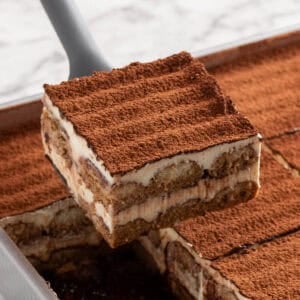 Square image for an Italian layered coffee and cream dessert sitting on a spatula