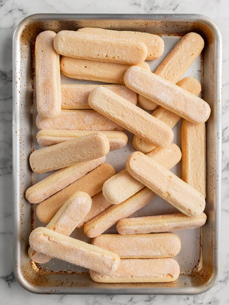 A shot of sponge fingers in a baking tray