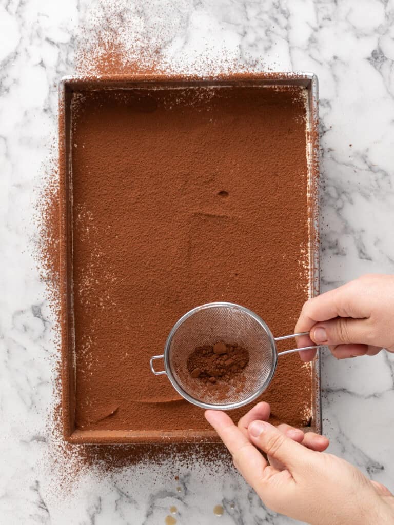 Add a second layer of cocoa powder on top using a sieve