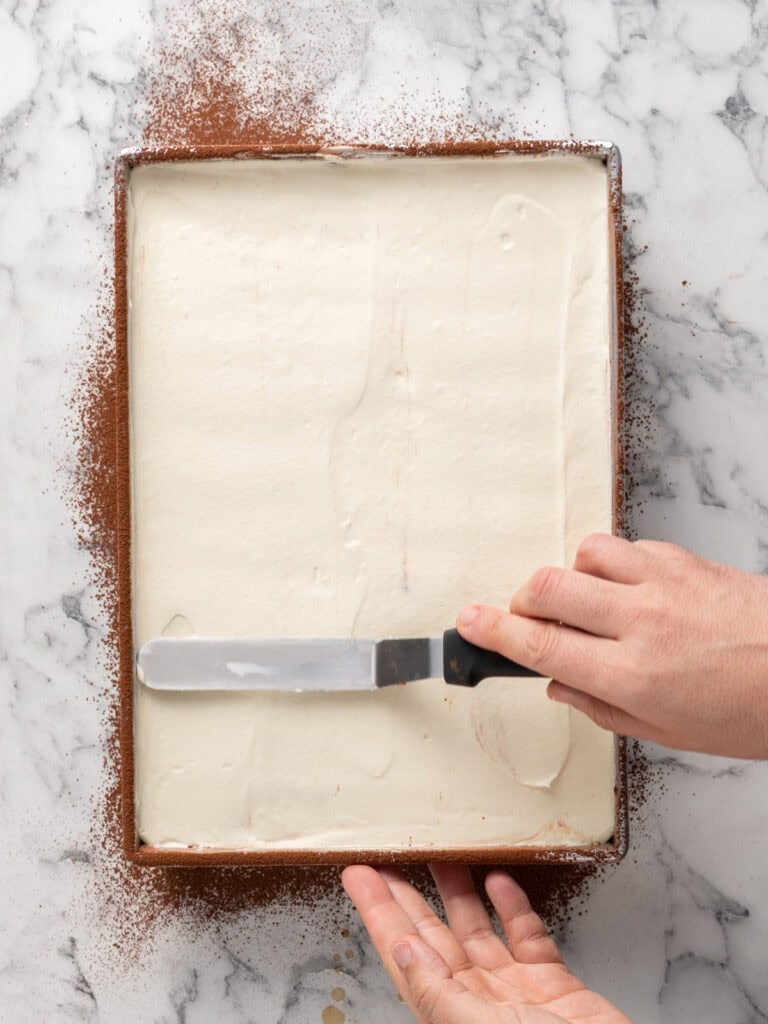 Add the second half of the cream layer and spread evenly