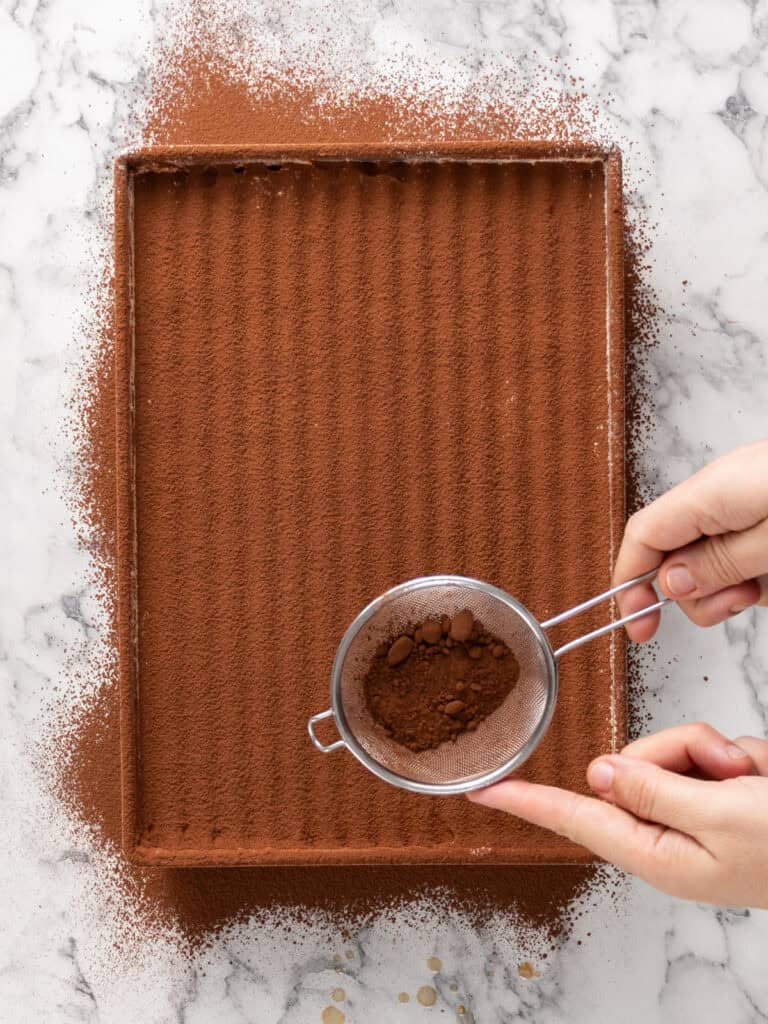 Add the final dusting of cocoa powder on top