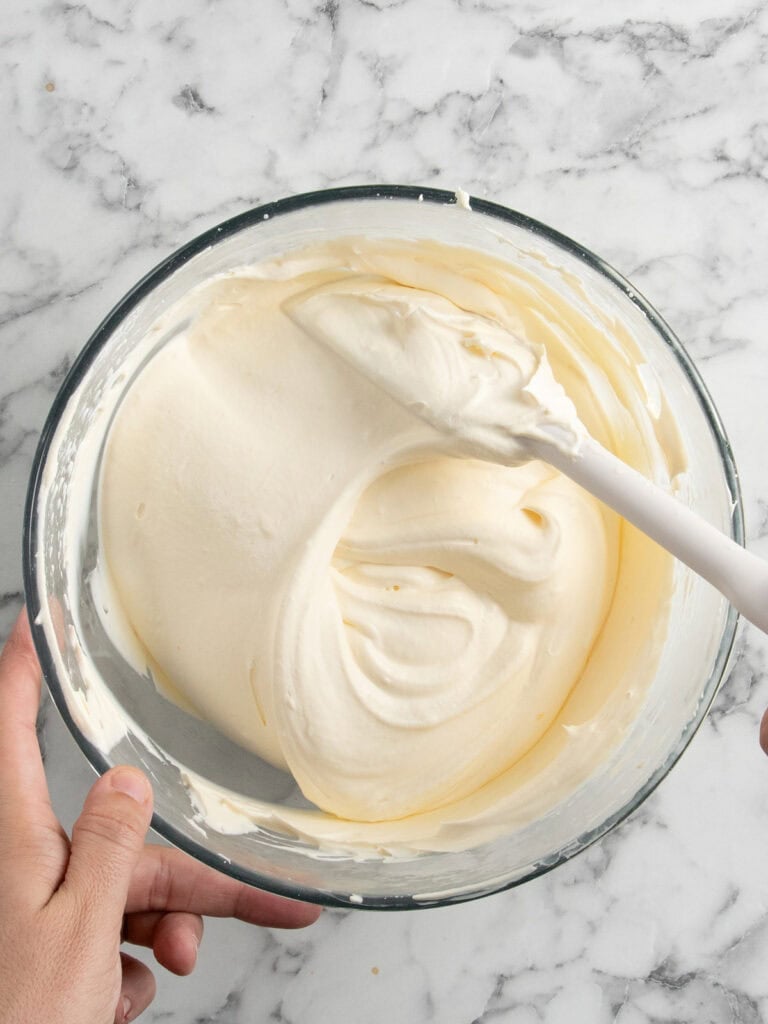 Fold the cream and egg yolks together.