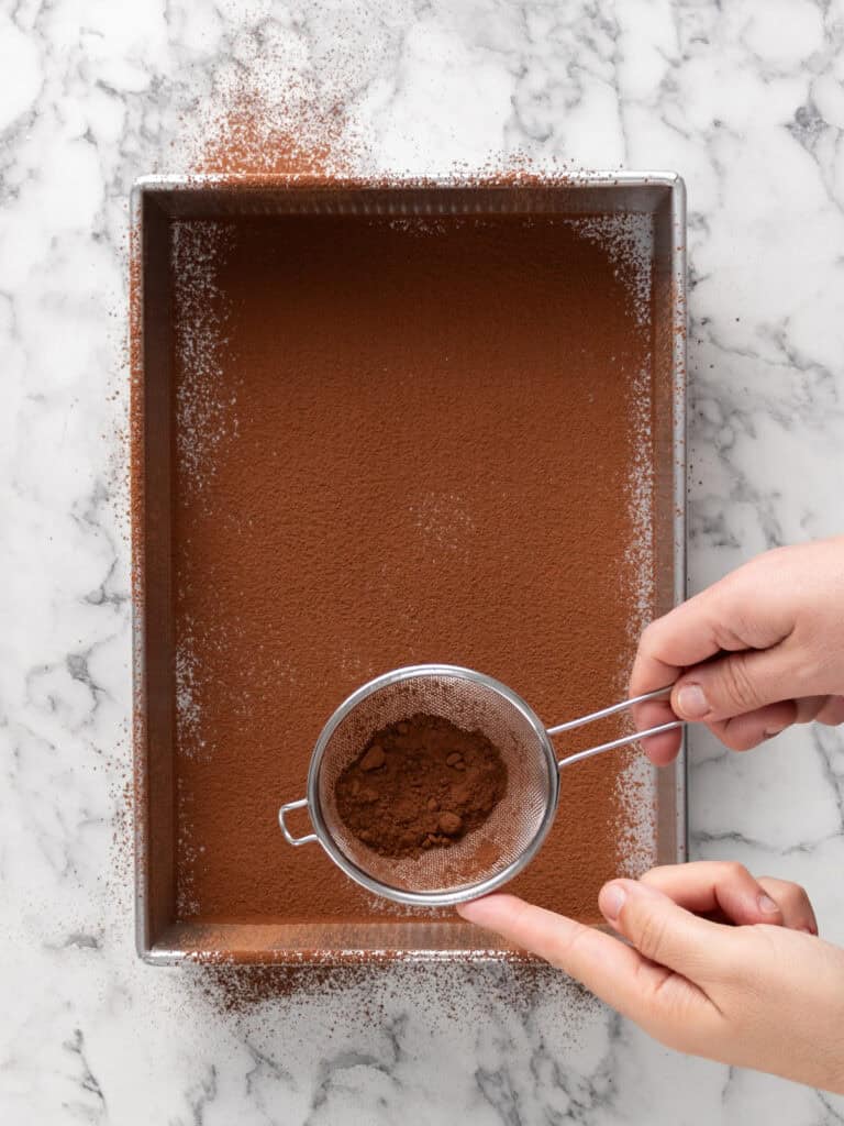 Dust the bottom of the dish with cocoa powder