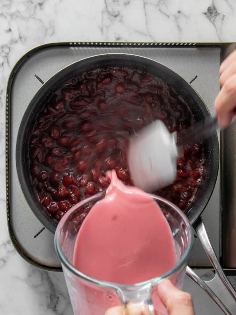 Adding the slurry to the simmering cherries